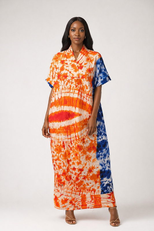 Woman wearing a tie-dye dress with orange, blue, and white pattern on a white background